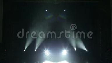 白色的光线在黑暗中交替地在舞台上闪现。 空的音乐会舞台。